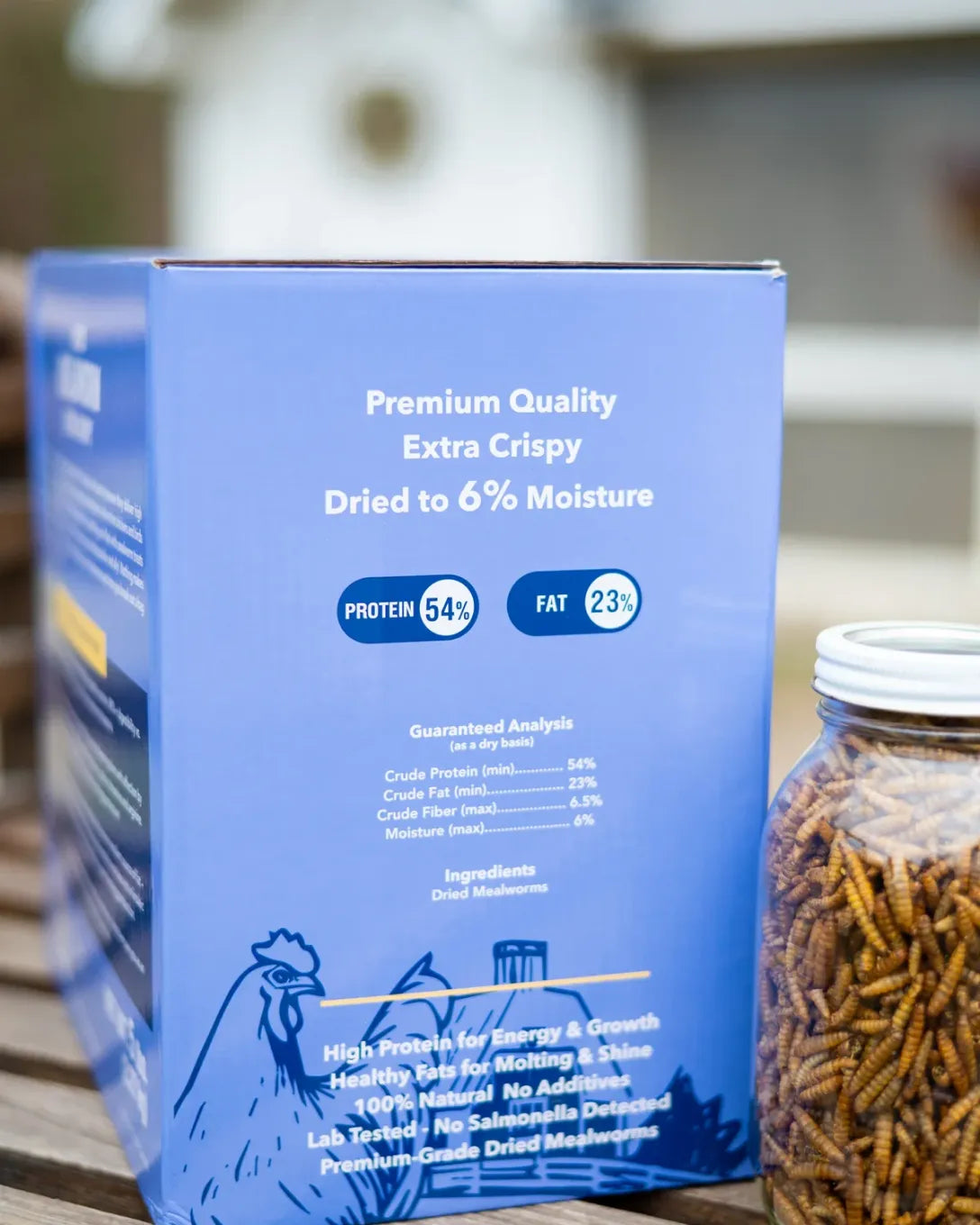 Blue packaging of dried mealworms with nutritional information on a wooden surface. 54% of protein 